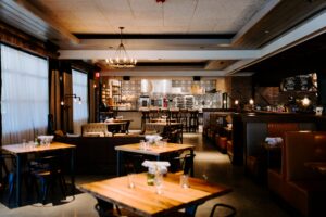 The dining room at Whiskey Cake houses a 100 Series square tabletop built by SouthLoft.