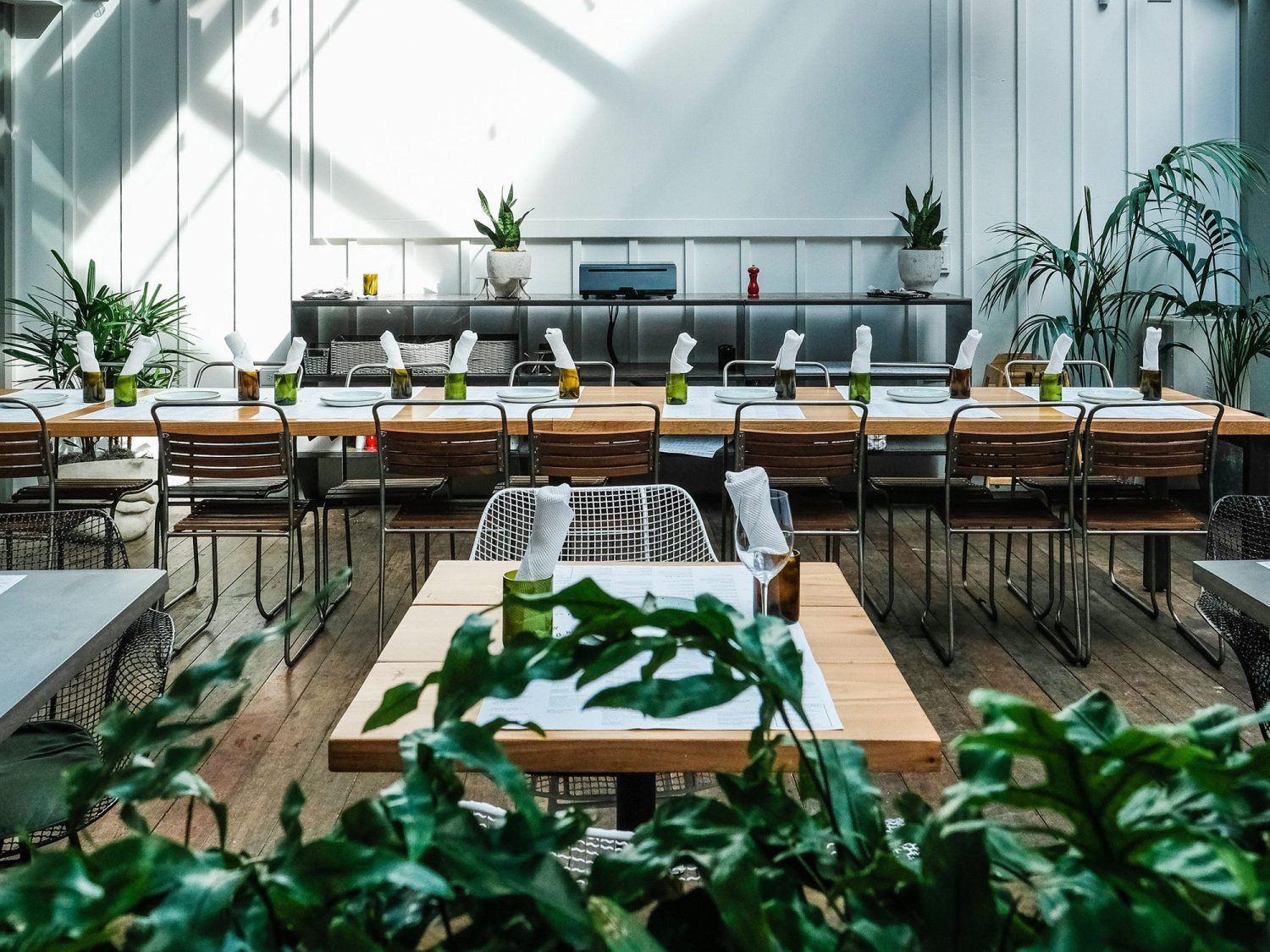White oak table built by SouthLoft sits in the dining space of 60 Vines.