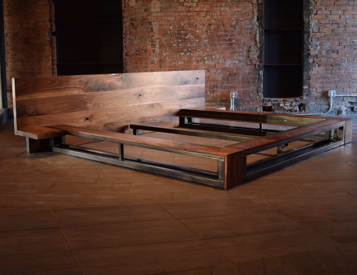 Custom platform bed frame with a solid wood headboard and industrial metal base by South Loft, designed for modern luxury interiors and handcrafted in Texas.