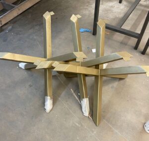 A pair of table bases await table tops in the SouthLoft shop.