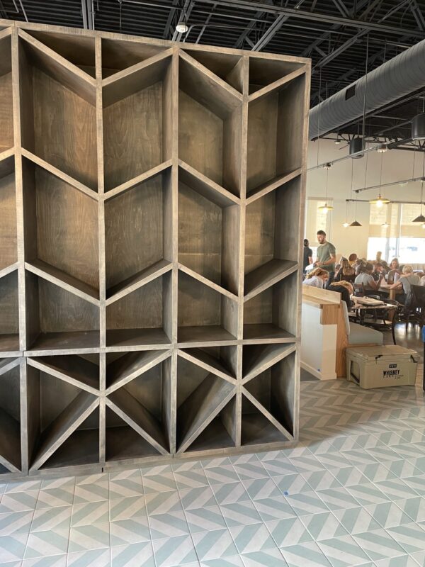 South Loft large custom geometric shelving unit with angular compartments in a modern industrial space.