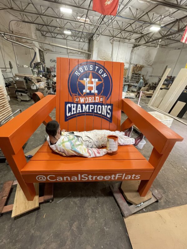 A large orange bench with Houston Astros 