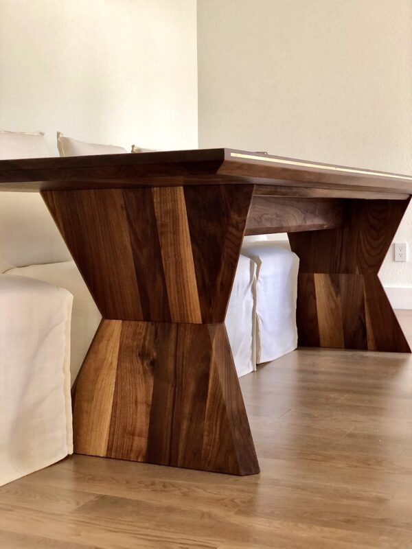 Modern custom dining table crafted from solid wood with unique geometric base design by South Loft, perfect for bespoke Texas homes and luxury interiors.