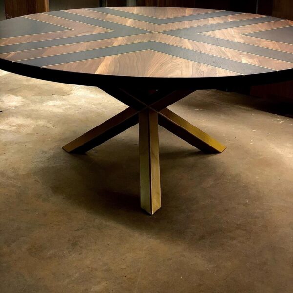 South Loft custom round wooden table with geometric inlay design and angled legs.