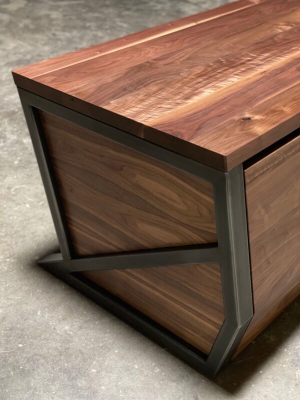 Close-up of South Loft executive desk highlighting the smooth wooden top and angular black frame.