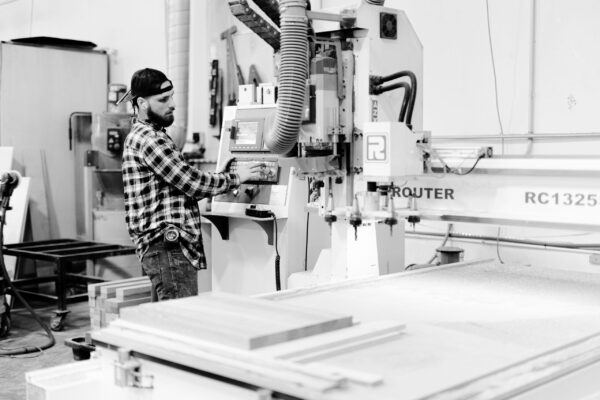 South Loft craftsman operating a CNC machine for precision woodwork.