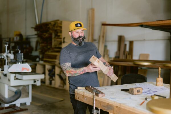 South Loft artisan inspecting a wooden component in the workshop.