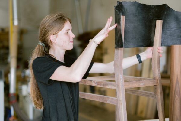 South Loft craftswoman working on a custom wood chair.