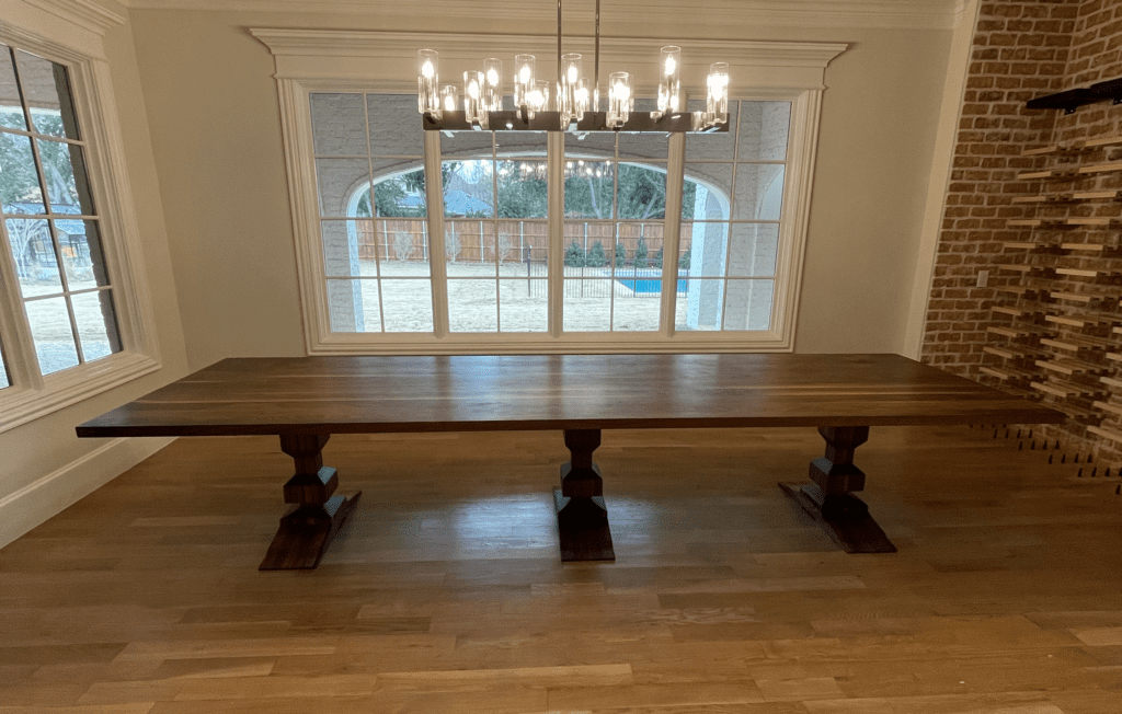 South Loft custom dark wood dining table placed in a well-lit dining room.