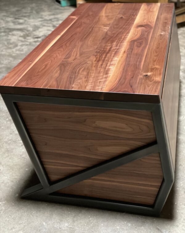 South Loft handcrafted walnut desk with angular steel framing, viewed from the side.