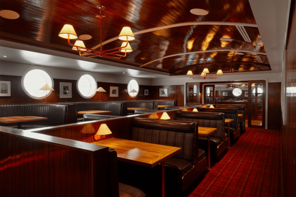 South Loft custom dining booths with wooden tables and soft lighting in a nautical-themed restaurant.
