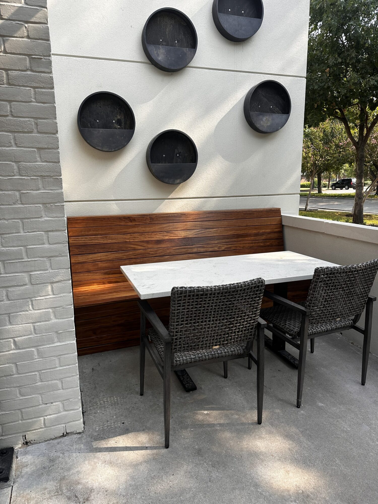 A wooden booth flanks a table and chairs at a Mexican Sugar location.